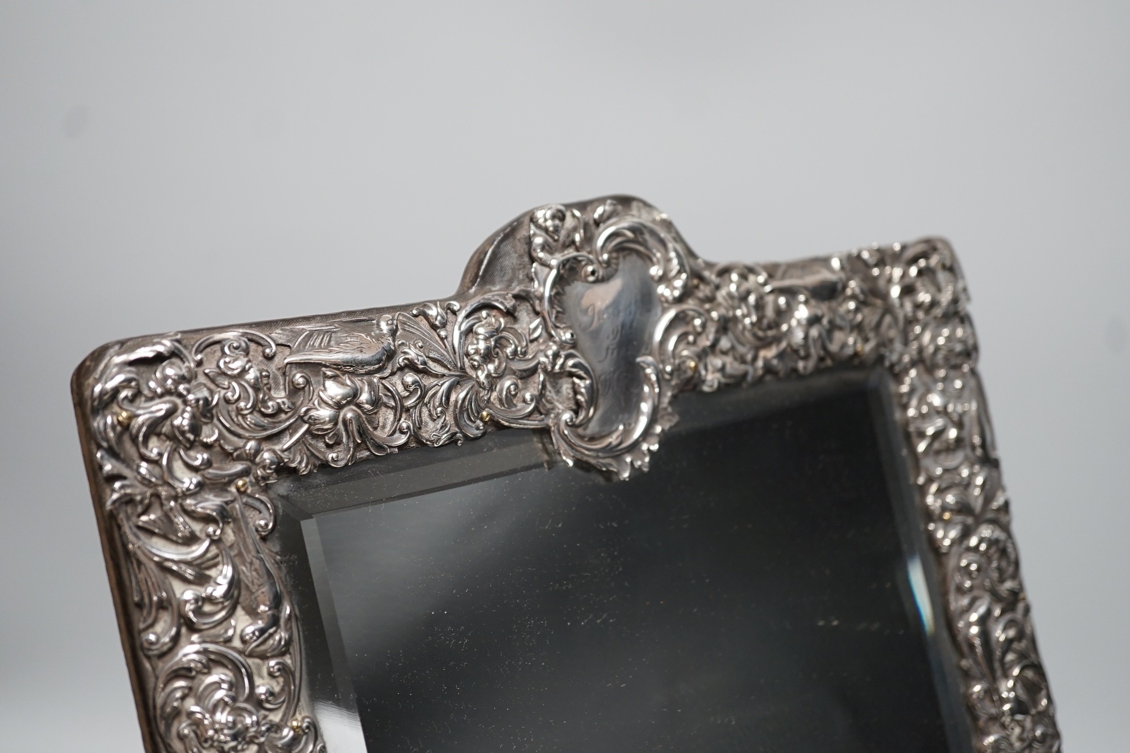 A late Victorian repousse silver mounted rectangular easel mirror, William Comyns, London, 1900, 39.8cm.